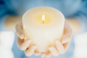 Hands Holding a Lit Candle
